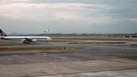 April 13,2018 : Singapore : Landscape view of Singapore airport with Singapore airline's plane taxing and another plane is taking off from the airport