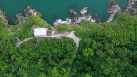 Aerial top view of ocean waves, beach and rocky coastline and beautiful forest. Beautiful nature background. island background and tropical with tourist. footage video 4k format. famous island.