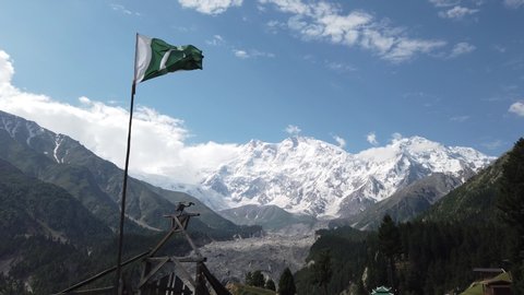 Waving Pakistani Flag at Fairy Meadows with with at the background Nanga Parbat Mountain locally known as Diamer, is the ninth highest mountain in the world at 8,126 metres above sea level. 