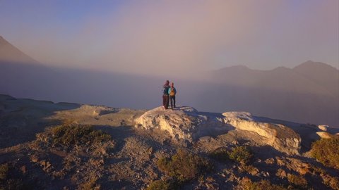 Aerial: People stay on the edge of crater Kawah Ijen volcano, East Java, Indonesia	
