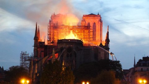 Paris, France -04.15.2019: Notre Dame de Paris still burning before the night.