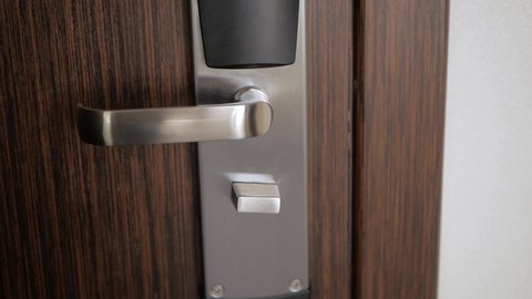 Wooden door with metal handle opens. Close-up