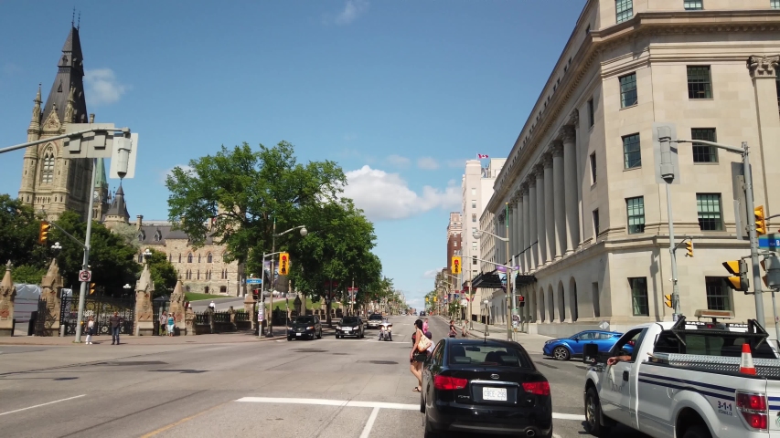 OTTAWA, CANADA - JULY 2019: Smooth and steady slow motion driving shot of Parliament Hill downtown