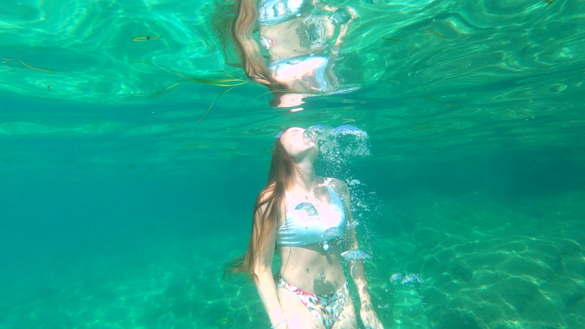 Young student female swimming underwater and having fun in summer | Shutterstock HD Video #1039331843