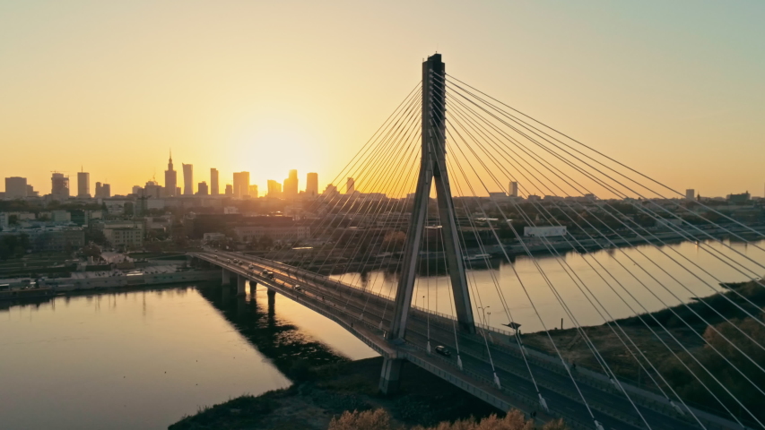 Establishing Aerial Panoramic Shot of Warsaw Cityscape, capital of Poland. Swietokrzyski Bridge and Downtown Skyline at Golden Sunset. 4K Panning Background Drone view Video with Copy Space Royalty-Free Stock Footage #1039336391