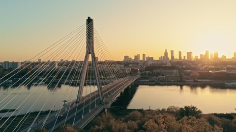 Establishing Aerial Panoramic Shot of Warsaw Cityscape, capital of Poland. Swietokrzyski Bridge and Downtown Skyline at Golden Sunset. 4K Panning Background Drone view Video with Copy Space