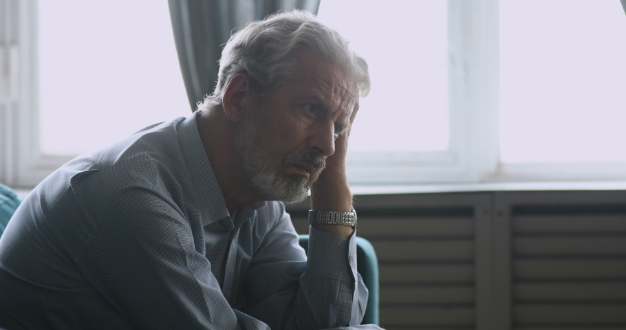 Upset senior adult man widower sitting alone at home feeling sad worried, depressed old elder grandpa feel pain anxiety grief sorrow suffer from loneliness mental dementia alzheimer disease concept | Shutterstock HD Video #1039337942