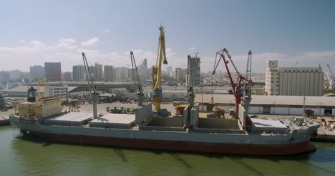 CASABLANCA, MOROCCO - October 15, 2019: Loading a cargo ship at the seaport. Port with large ships and cranes, timelapse.