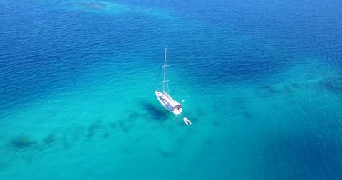 Aerial orbit shot around white sailing yacht. Sailing holiday, exploring, adventure. Maldives.