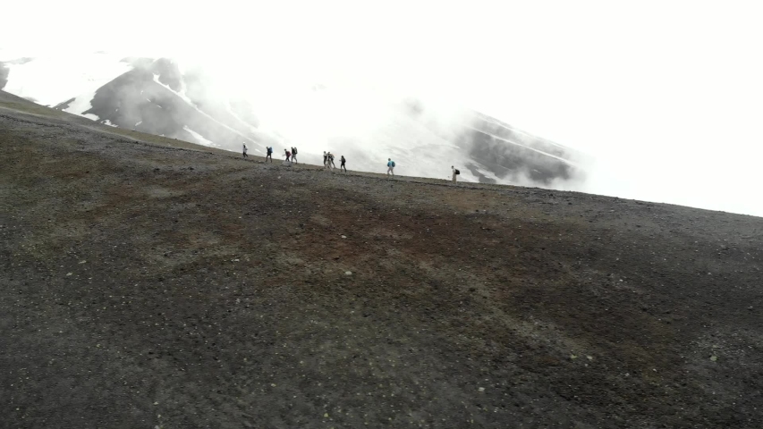 people climb the volcano shooting drone
