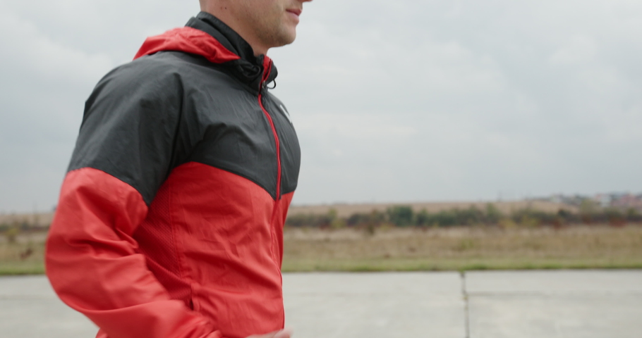 Adult sportsman running on spot in nature