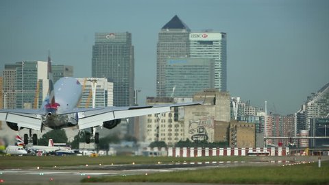 London, Summer 2014. A Commercial Aircraft full of passengers departs from London City Airport. This unique airport is right in heart of the city close to transport links, perfect for business travel.