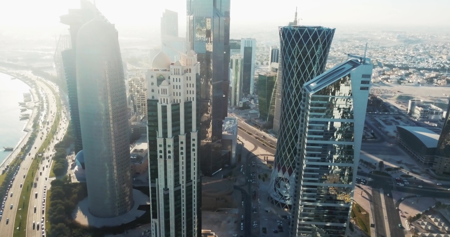 High rising aerial view of a global developed city with skyscrapers and towers, Doha West Bay area in Qatar, middle east, at sunset Royalty-Free Stock Footage #1039363844