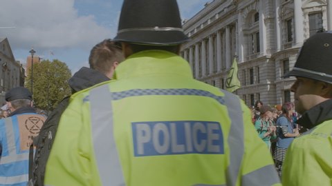 London , London / United Kingdom (UK) - 10 09 2019: Extinction Rebellion demonstration on Whitehall road in Westminster with police officers standing on guard.