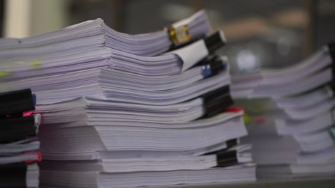 Piles unfinished documents reports files with overwork paper corner on teacher school desk office at university. Stack of messy paperworks assessment legal folder at workplace, tax audit concept