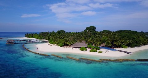 Paradise island surrounded by beautiful turquoise seascape, Fiji aerial slow rotating view