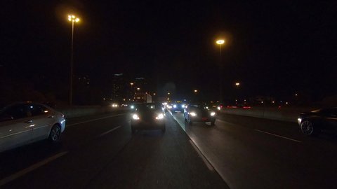 Toronto, Ontario, Canada October 2019 Driving plate reverse POV at night on busy highway through Toronto