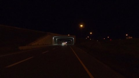 Toronto, Ontario, Canada October 2019 Driving reverse POV at night on busy highway through Toronto