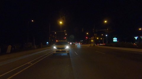 Toronto, Ontario, Canada October 2019 Driving reverse POV at night on busy highway through Toronto