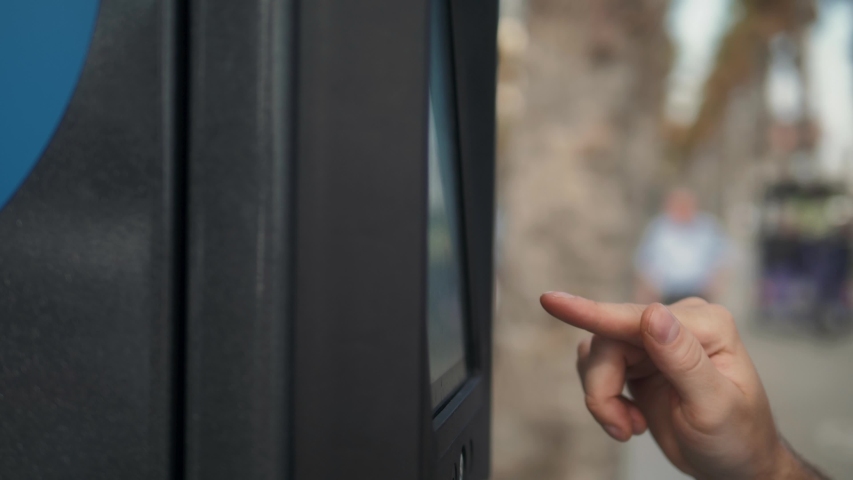 man inserting a parking lot ticket at an automated pay machine pay with card. Cash Automated machines parking lot in city attendants.