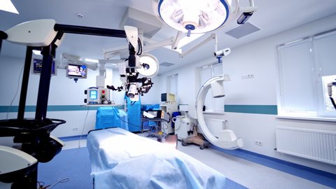 VINNITSA, UKRAINE - September 2019: Modern operating room with new technological equipment. Light surgical room in the neurosurgical department. Camera moves around.