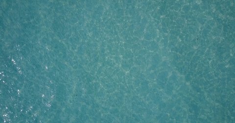 Astonishing sea texture of a drone top view video flying fast over turquoise surface in Koh Rong Saloem, Cambodia