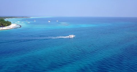 Aerial view of white tourist boat sailing to the deep sea along ocean streams in Mentawai Islands