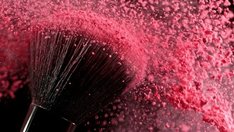 Super Slow Motion Closeup Shot of Pink Makeup Powder Falling from Facial Brush at 1000fps.