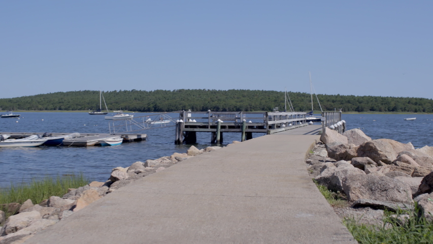 First person view walking onto a dock at the lake