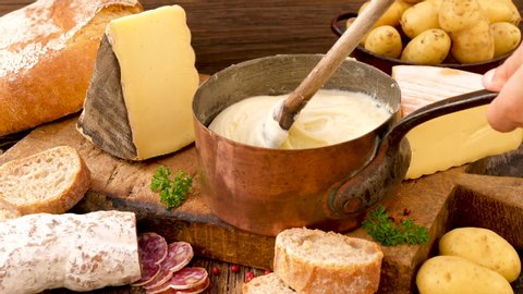 French aligot, cheese fondue with bread, salami and potato