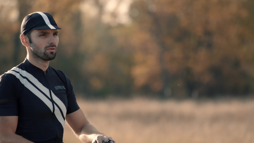 Cyclist Wearing Helmet Before Competition. Triathlete Puts On Helmet And Sunglasses On Triathlon Competition. Portrait Athlete After Cycling. Cyclist In Lycra Sportswear And  Cap. Sport Concept