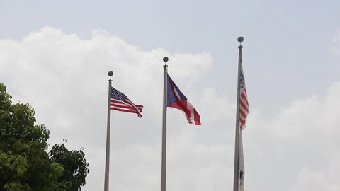 Flag of USA and Puerto Rico relation in San Juan stock video in Full HD I USA and Puerto Rico flags waving with beautiful skies in the back stock video 