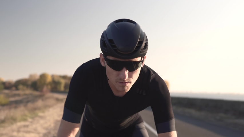 Cyclist Rider In Helmet And Sportswear Riding Workout At Sunset On Triathlon Time Trial Bicycle.Cyclist Professional Fit Man On Triathlon Bicycle.Triathlete Training On Bike.Cycling Exercise On Bike. | Shutterstock HD Video #1039457789