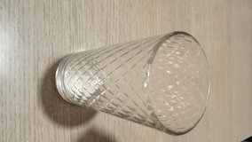 pours orange juice into a glass, vertical video