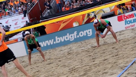 THE HAAG, NETHERLANDS - JULY 7th 2015: Brazilian beach volleyball players Alison Cerutti and Bruno Schmidt play against Dutch team during the World Cup Gold Final