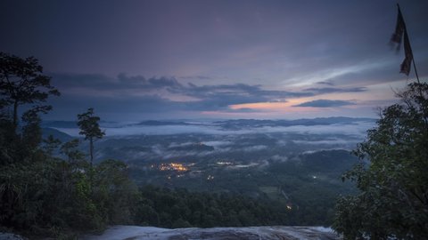Time-lapse of moving stratus clouds across over the small city, view from Baha camp,mount Stong, Kelantan Malaysia during sunrise.