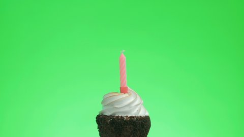 Lighting a red candle on a delicious cupcake, green screen