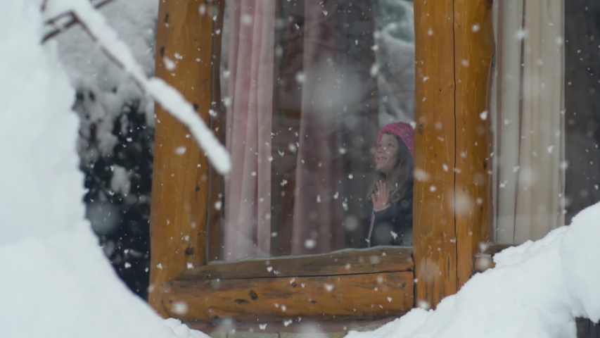 Little Girl Watching the Snow fall