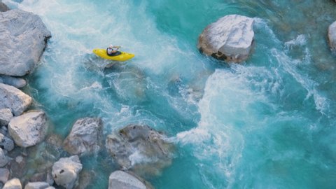 A man kayaking through rapids