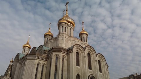 Hyperlapse temple of New Martyrs and Confessors golden domes cross Lubyanka Moscow architecture Russia Orthodox Church Monastery modern sight. Faith culture historical. Sunny blue sky clouds. Forward