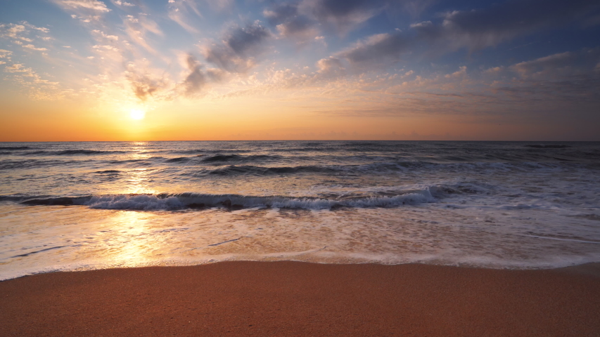 Golden sea sunrise and washing waves on the beach | Shutterstock HD Video #1039504415