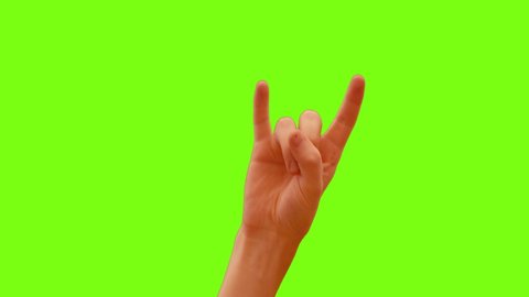 Hand showing rock n roll finger gesture on green screen, close up