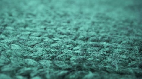 Extreme detail view of sheep wool cloth texture in macro dolly shot. Flowing animal fiber material for handcraft knitting. Textile abstract background. Winter fashion clothing industry concept.