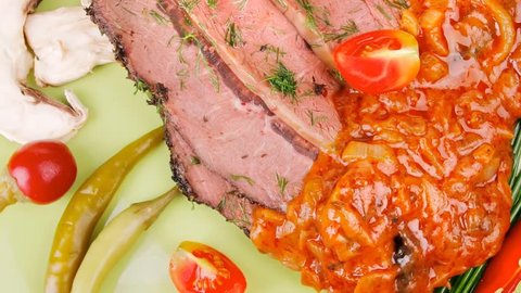 hot roast corned beef on green plate with red spiced tomato sauce over wooden table 1920x1080 intro motion slow hidef hd