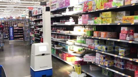 Somerdale, New Jersey - October 20, 2019: A robot is seen maneuvering on
its own down an aisle while shining a light on products as it automatically takes inventory at a Walmart store. 