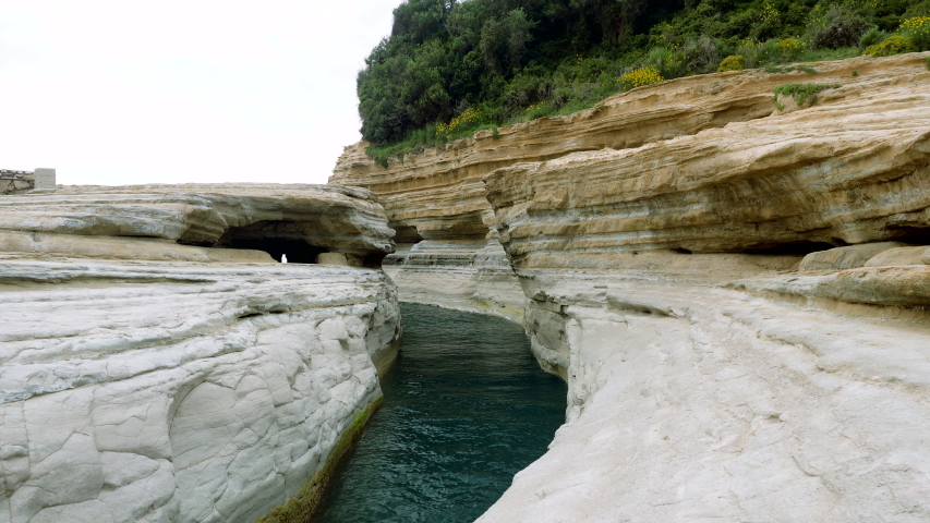 Landscape of mountain and blue sea. Rocky shore of the Mediterranean coast in Greece. 4K