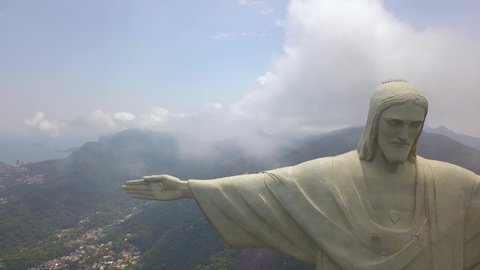 Rio De Janeiro / Brazil - 08 31 2019: Famous Christ The Redeemer aka Cristo Redentor Jesus Statue Close Up Pull Back Aerial