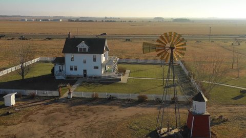 YORK, NEBRASKA - CIRCA 2018 - A drone aerial establishing shot of a classic farmhouse farm and barns in rural midwest America, York, Nebraska.