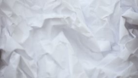 Crumpled sheet of paper. Live wallpaper background. Slow motion. Place for text, title