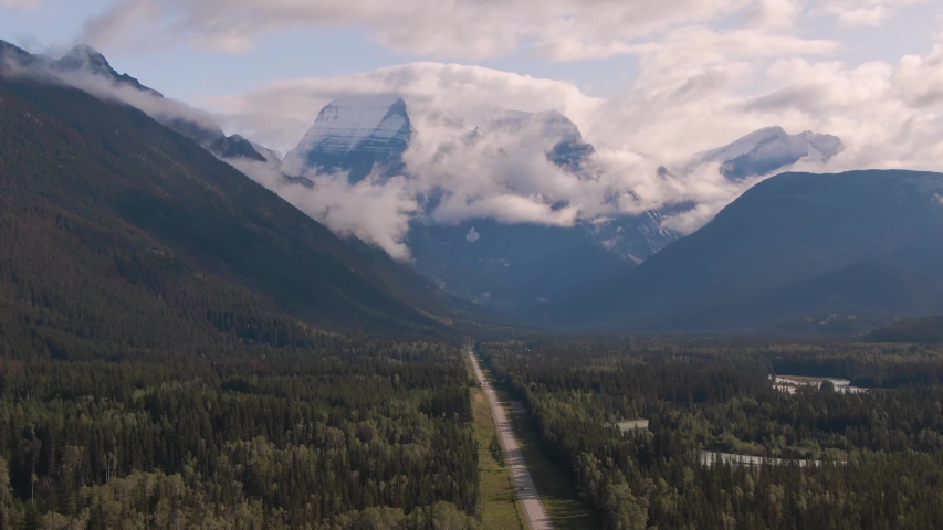 Aerial Panoramic View of Scenic Road in the Beautiful Canadian Mountain Landscape during a sunny and cloudy summer sunrise. Taken near Mt Robson, British Columbia, Canada.